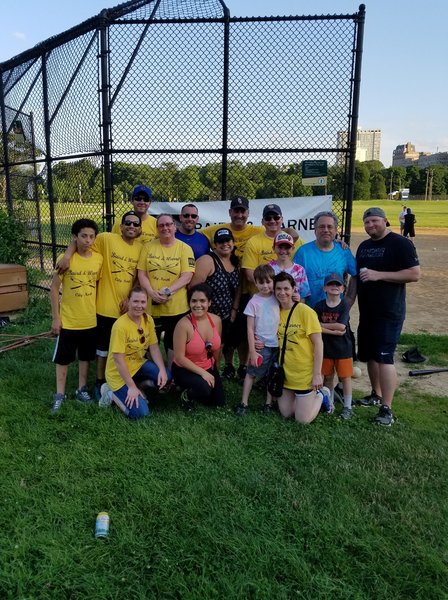 Team members of Baird & Warner North Center enjoy a softball game